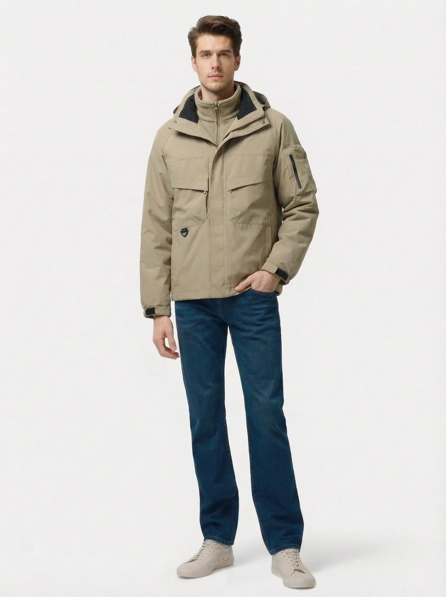 Man wearing a beige jacket and blue jeans