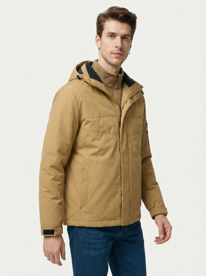 Man wearing a tan hooded jacket on a white background