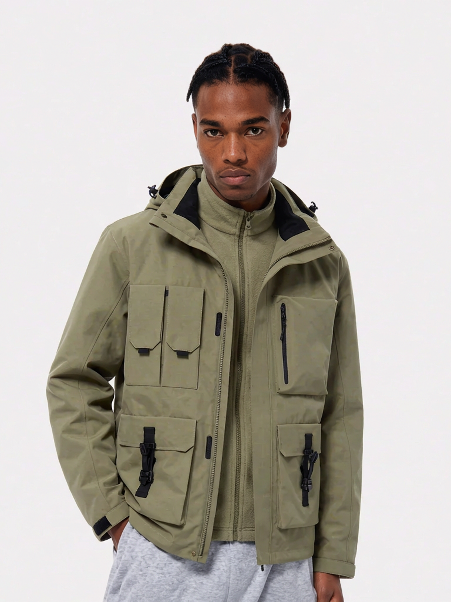 Person wearing a green jacket with multiple pockets