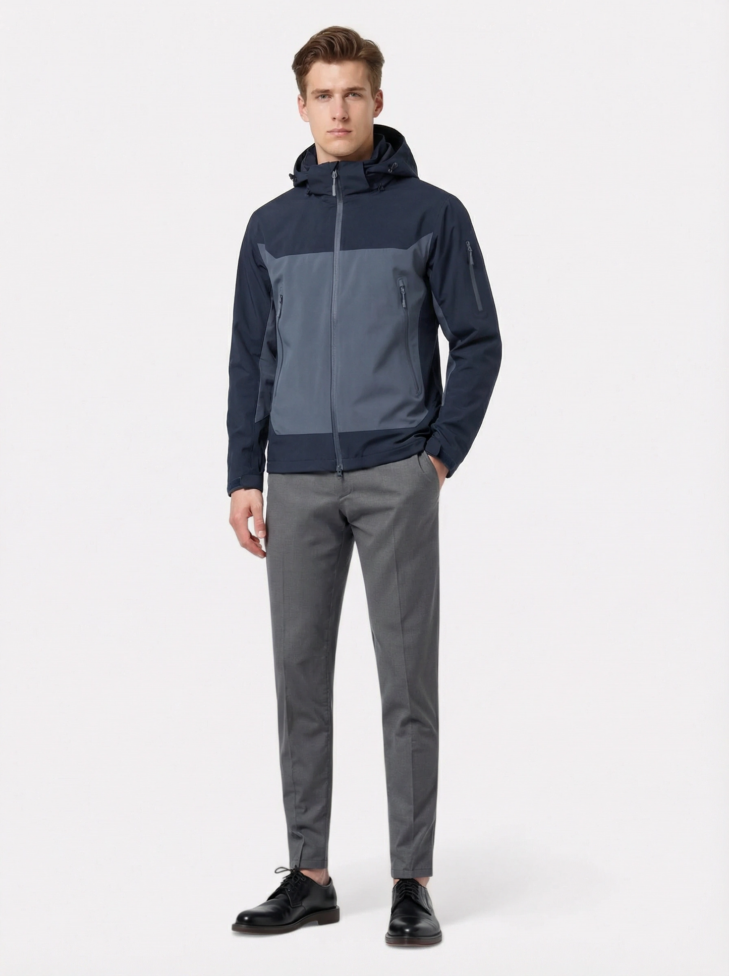 Man wearing a two-tone jacket and gray pants 