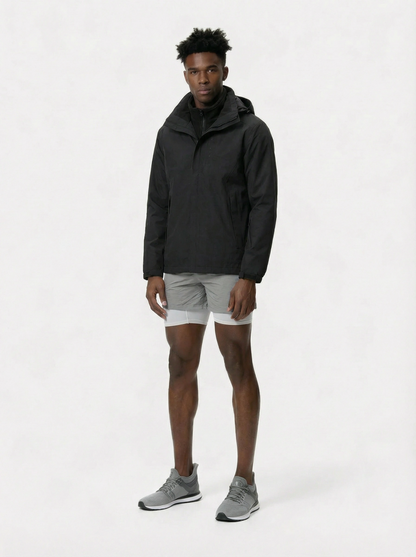 Person wearing a black jacket and gray shorts