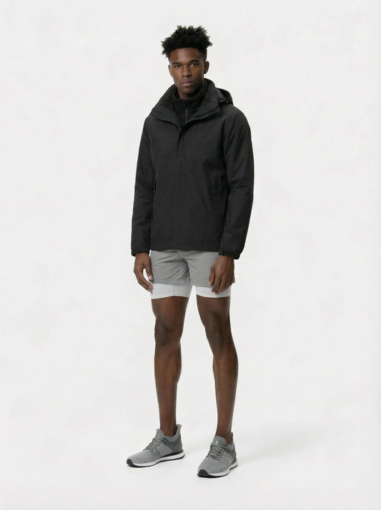 Person wearing a black jacket and gray shorts