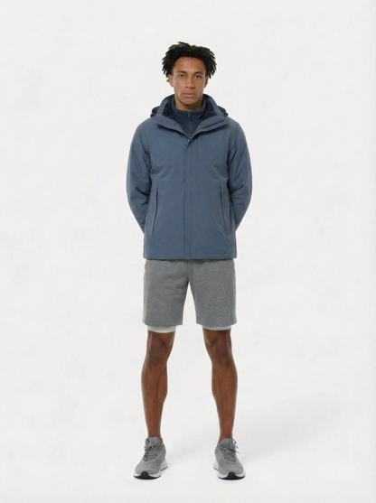Person wearing a blue jacket and gray shorts