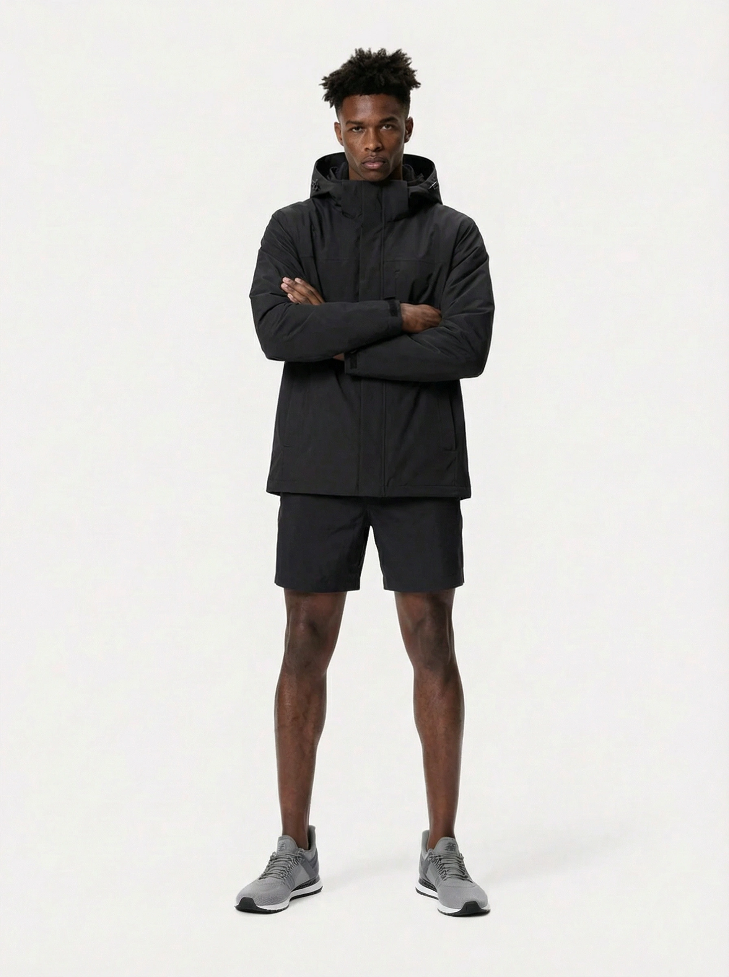 Man wearing a black jacket and shorts 