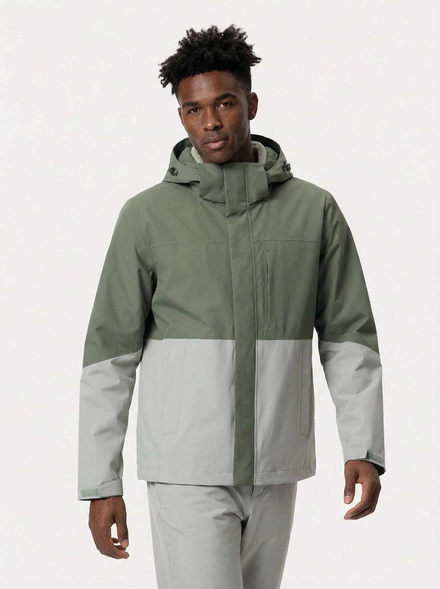 Person wearing a two-tone green and gray jacket 