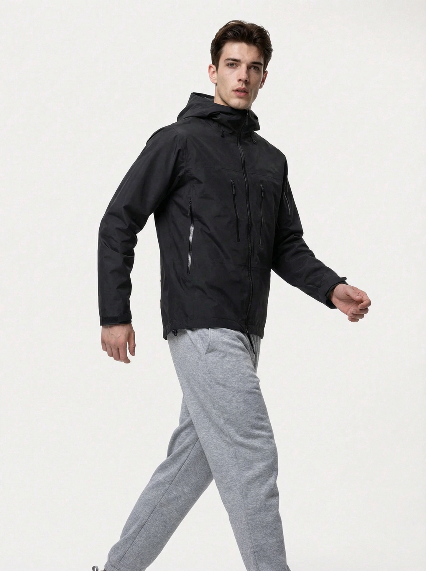 Man wearing a black jacket and gray pants 