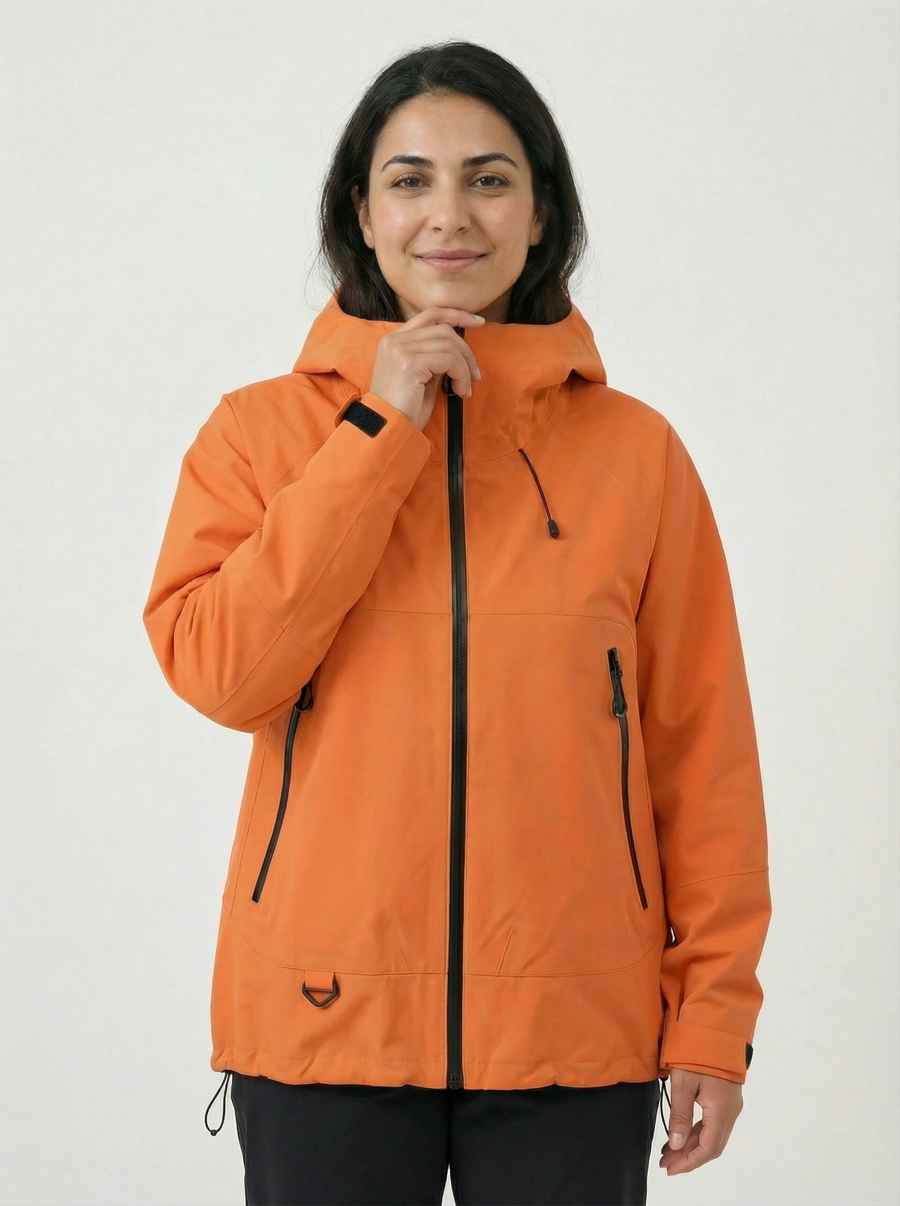 Person wearing an orange jacket with black zippers